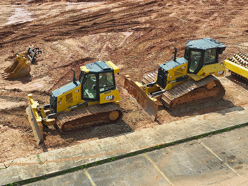 4H cat bulldozers in a line.